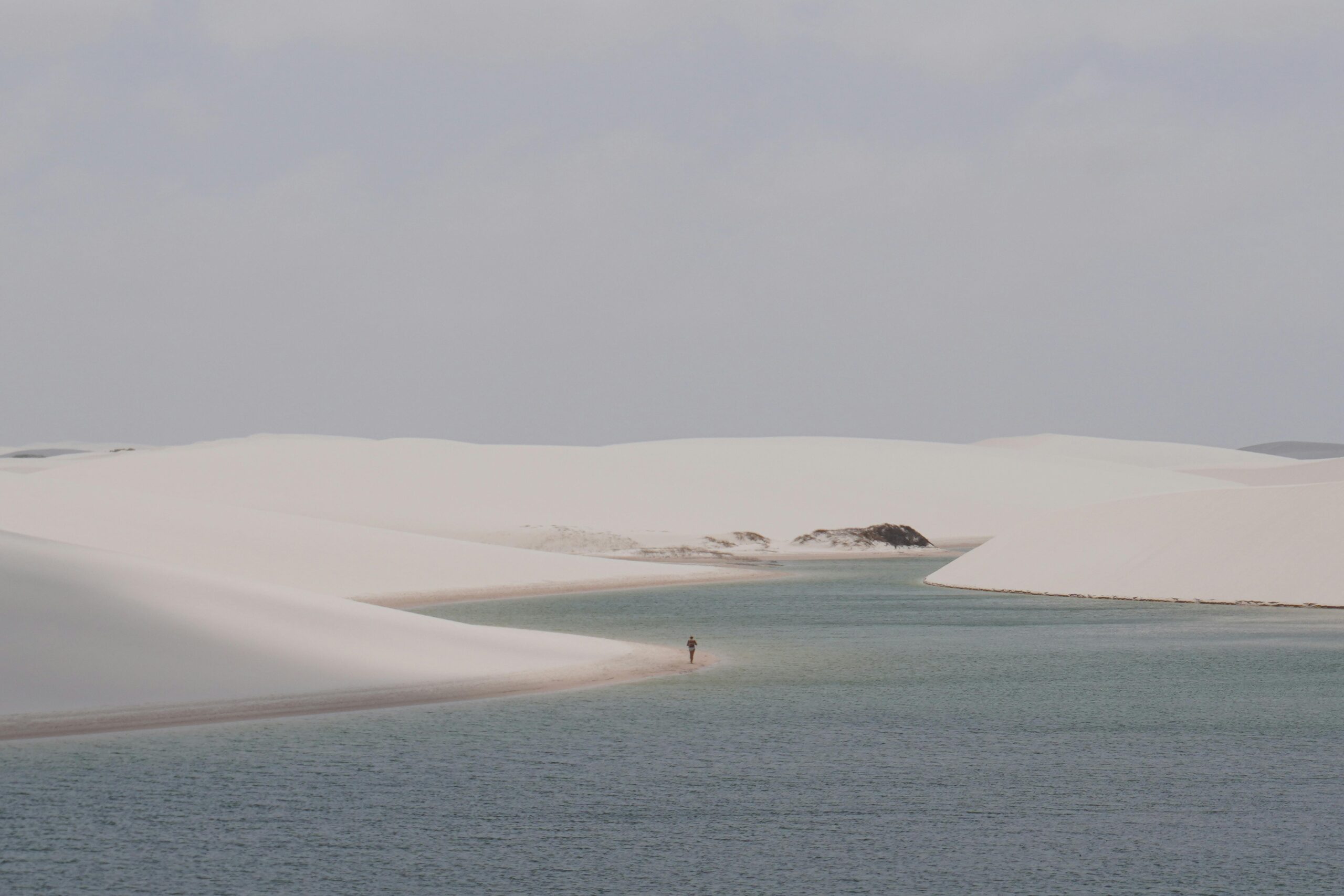 Peaceful view of Atins' sand dunes and lagoons in Lençóis Maranhenses National Park, Brazil.